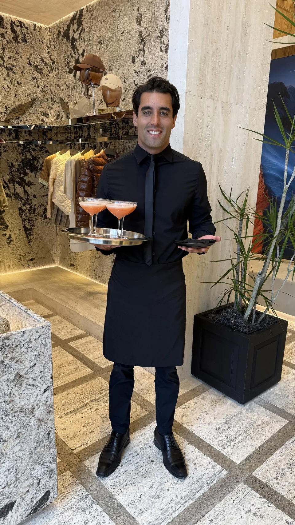 A Maison Doré team member serving guests at an event in Miami